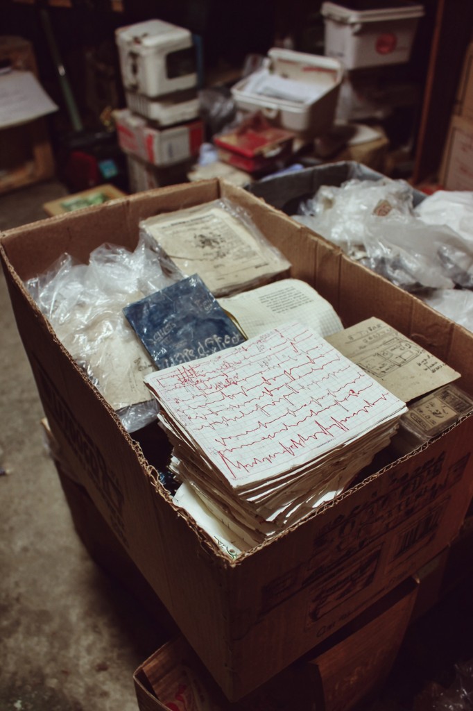 Box in the basement filled with handwritten EKG charts and documents